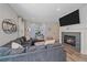 Comfortable living room with a cozy fireplace and large sectional, perfect for relaxing and entertaining at 21392 E Stroll Ave, Parker, CO 80138