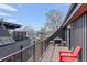 Rooftop balcony features a table, chairs, city views, and sleek railings perfect for outdoor relaxation at 4454 Utica St, Denver, CO 80212