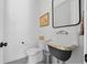 Charming powder room with unique fixtures, stylish black and white flooring, and elegant decor for guests at 4454 Utica St, Denver, CO 80212