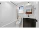 This bathroom features a tiled shower and tub, a vanity, and a modern toilet at 4454 Utica St, Denver, CO 80212
