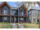 Contemporary two-story home with a black exterior, charming balconies, and manicured front yard at 4454 Utica St, Denver, CO 80212