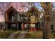 Modern two-story home with a black exterior, inviting front porch, and well-maintained lawn at 4454 Utica St, Denver, CO 80212
