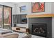 Living area highlighting a contemporary fireplace with a wooden mantel and modern decor at 4454 Utica St, Denver, CO 80212