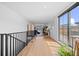 Bright hallway leading to a living area and a balcony with modern railings and natural light at 4454 Utica St, Denver, CO 80212