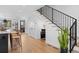 Modern interior with staircase, hardwood floors, and a glimpse into kitchen and living space at 4454 Utica St, Denver, CO 80212
