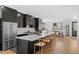 Bright, spacious kitchen features a large island with seating, stainless steel appliances, and an open layout to the dining area at 4454 Utica St, Denver, CO 80212