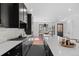 Bright modern kitchen with island, stainless appliances, and view to dining area at 4454 Utica St, Denver, CO 80212