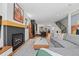 Spacious living room with a fireplace, open layout, and stylish decor connecting to kitchen and staircase at 4454 Utica St, Denver, CO 80212