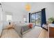 Bright, airy main bedroom features a private balcony, vaulted ceiling, and stylish decor, creating a relaxing retreat at 4454 Utica St, Denver, CO 80212