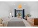Serene main bedroom boasts vaulted ceiling, large windows, and comfortable furnishings, creating a peaceful retreat at 4454 Utica St, Denver, CO 80212