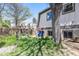 Private backyard featuring mature trees, a garden, wood fence, and exterior siding at 9349 E Chenango Ave, Greenwood Village, CO 80111