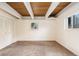 Basement space showcasing neutral carpet, wood ceilings, and bright, white-painted walls at 9349 E Chenango Ave, Greenwood Village, CO 80111