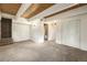 Basement featuring neutral carpet, wood ceilings, and bright, white-painted walls at 9349 E Chenango Ave, Greenwood Village, CO 80111
