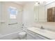Bright bathroom featuring white subway tiles, vanity with a white countertop, and a window at 9349 E Chenango Ave, Greenwood Village, CO 80111