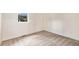 An empty bedroom with neutral carpet and white walls, featuring a view from a window at 9349 E Chenango Ave, Greenwood Village, CO 80111