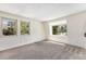 Bright bedroom featuring large windows, neutral carpet, and natural light at 9349 E Chenango Ave, Greenwood Village, CO 80111