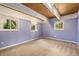 Spacious bedroom featuring wood plank ceilings, three windows, and a comfortable carpet at 9349 E Chenango Ave, Greenwood Village, CO 80111