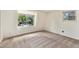 A spacious bedroom with neutral carpet, white walls, and a window with a view of the outdoors at 9349 E Chenango Ave, Greenwood Village, CO 80111