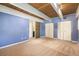 Cozy bedroom featuring white closets, wood ceilings, plush carpet, and blue-painted walls at 9349 E Chenango Ave, Greenwood Village, CO 80111