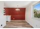 Bright dining area featuring wood floors, a modern chandelier, and a large window at 9349 E Chenango Ave, Greenwood Village, CO 80111