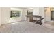 An open living room with neutral carpet and large windows offering views of the outdoors at 9349 E Chenango Ave, Greenwood Village, CO 80111