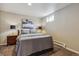 This cozy bedroom features a queen bed, soft lighting, and modern artwork creating a restful atmosphere at 176 W Elm St, Elizabeth, CO 80107