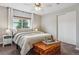 Bright bedroom with neutral tones and lots of natural light and a cedar chest at 176 W Elm St, Elizabeth, CO 80107