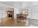 Open-concept dining room flowing into the kitchen, featuring a wooden table set and modern flooring at 176 W Elm St, Elizabeth, CO 80107