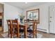 Cozy dining room with a wood table, six chairs, and a window for natural light at 176 W Elm St, Elizabeth, CO 80107