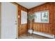 Cozy entryway featuring wood paneling, a bright window, and a decorative potted plant at 176 W Elm St, Elizabeth, CO 80107