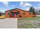 Charming single-story home with orange siding, cozy front porch, and well-maintained lawn at 176 W Elm St, Elizabeth, CO 80107