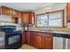 Functional kitchen featuring dark cabinets, updated appliances, and a bright window view at 176 W Elm St, Elizabeth, CO 80107