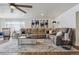 Bright living room featuring a large sectional sofa, area rug, and ample natural light at 176 W Elm St, Elizabeth, CO 80107