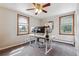 Office area with built in desk and large picture windows for natural light at 176 W Elm St, Elizabeth, CO 80107