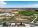 Scenic aerial shot of a neighborhood with a park featuring baseball field, playground, and green spaces nearby at 13970 Craig Way, Broomfield, CO 80020