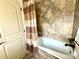 This bathroom features tiled walls, a shower curtain and a bathtub with a jacuzzi at 13970 Craig Way, Broomfield, CO 80020