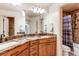 This bathroom features dual sinks with granite counters and an attached bath and toilet at 13970 Craig Way, Broomfield, CO 80020