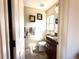 A powder room with neutral colors features an elegant mirror and modern vanity at 13970 Craig Way, Broomfield, CO 80020