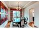 Bright dining area with modern decor, wood floors, and a view of the backyard through large windows at 13970 Craig Way, Broomfield, CO 80020