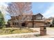 Beautiful two-story home with a three-car garage, landscaping, and a charming tree-lined front yard at 13970 Craig Way, Broomfield, CO 80020