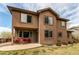 The house's backyard features a patio with furniture and green shrubs at 13970 Craig Way, Broomfield, CO 80020