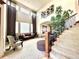 Impressive two-story foyer with curved staircase, high windows, stylish decor, and lots of natural light at 13970 Craig Way, Broomfield, CO 80020