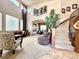 Grand foyer showcases a winding staircase, soaring ceilings, large windows, and a view into the dining room at 13970 Craig Way, Broomfield, CO 80020