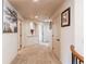 Hallway with neutral carpet, picture, wall niche, and multiple doorways at 13970 Craig Way, Broomfield, CO 80020