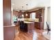 Gourmet kitchen with dark wood cabinetry, granite countertops, stainless steel appliances, and a large island at 13970 Craig Way, Broomfield, CO 80020