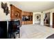 Spacious living room featuring a fireplace, built-in shelving, piano and open floor plan at 13970 Craig Way, Broomfield, CO 80020
