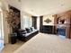 Cozy living room with plush leather couch, fireplace, grand piano, and large windows with custom curtains at 13970 Craig Way, Broomfield, CO 80020