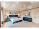 Relaxing main bedroom featuring a large bed, dark wood furniture, recessed lighting and a tray ceiling at 13970 Craig Way, Broomfield, CO 80020