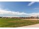 Beautiful park view with lush green grass, playground and baseball field, offering a serene and recreational community space at 13970 Craig Way, Broomfield, CO 80020