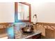 Stylish powder room with decorative mirror and vessel sink at 13970 Craig Way, Broomfield, CO 80020